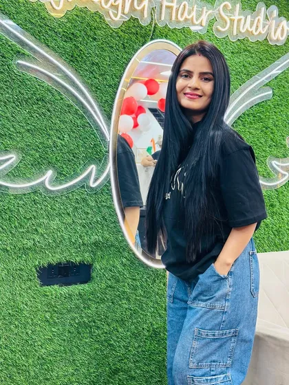 Posing by our signature angel wings. This client's sleek, straight hair is the result of our nourishing Botox treatment.
