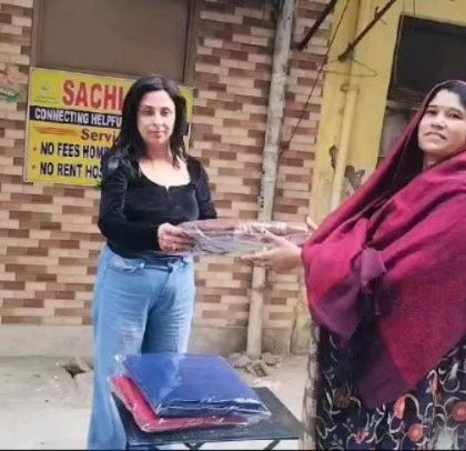 A wide shot of the blanket donation drive, showing the stacked blankets ready for distribution. This represents the collective effort of our donors and volunteers.