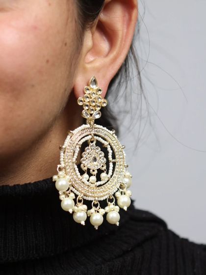 A few pearls entangled in a way that is sharper than my outfit, but not than my confidence. A model wears our kundan and pearl chandbali hoops, a perfect blend of modern and traditional.