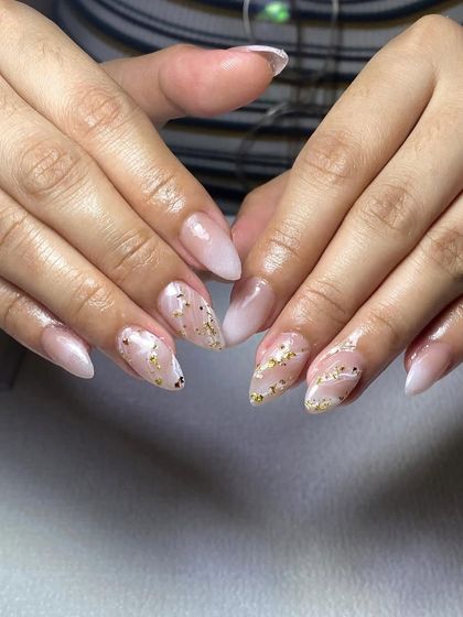 A soft and sparkly design. These almond-shaped extensions have a milky base with scattered gold flakes for a touch of subtle glamour.