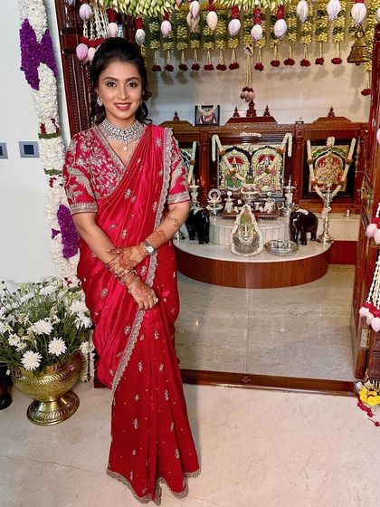 A full-length shot showing the elegant saree and the festive home decor.