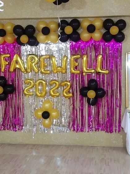A festive backdrop for a "Farewell 2022" party, using a shimmer curtain and foil balloons.