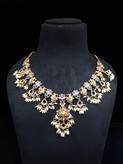 A captivating necklace with clusters of pearls and multi-color stones. This unique design is sure to make a statement at any event.
