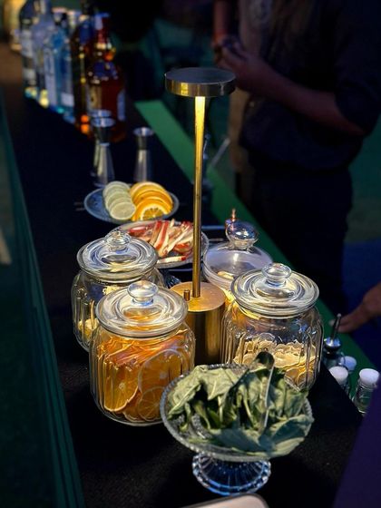 Another view of the garnish station at one of my bars, with jars of dehydrated citrus and bowls of fresh herbs.