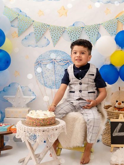 Birthday boy Shivansh is looking dapper in his vest and ready to celebrate turning four in this fun, sky-themed setup.