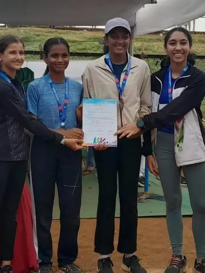 Our victorious Under 16 girls' 4x100 relay team receiving their bronze medal and certificate. Teamwork and coordination are key skills we instill in our athletes.