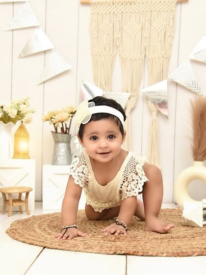 A beautiful crawling pose in a light and airy boho-themed setup. The mix of textures and natural elements makes for a visually interesting yet simple portrait.