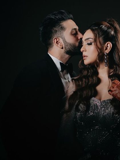 A tender forehead kiss from Krishnan to Ritika. This classic pose, captured with our signature moody lighting, emphasizes intimacy and protective love, creating a timeless and romantic portrait.