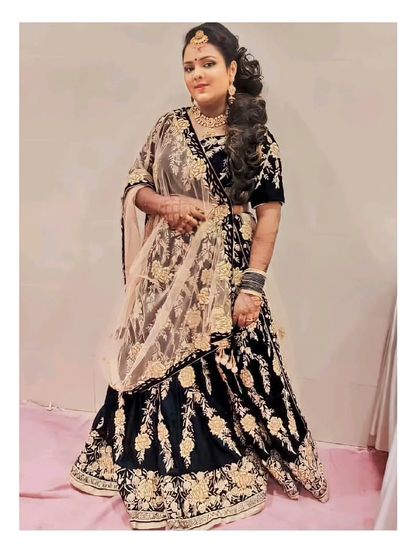 Our client looking radiant in a black and gold velvet lehenga. This is a great option for a winter wedding reception or sangeet.