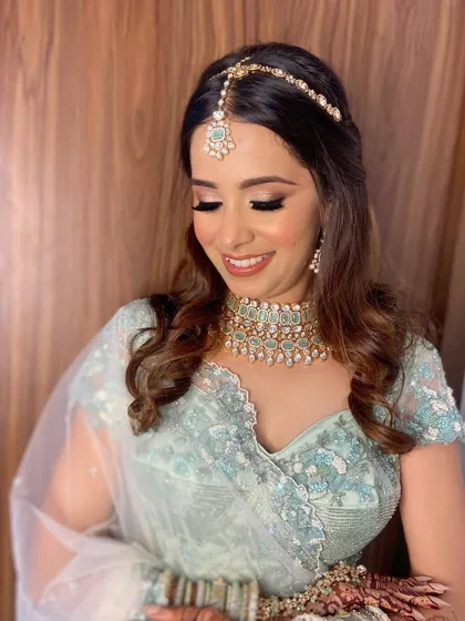 A beautiful shot of Aashna's makeup with her eyes closed, highlighting the seamless blending and soft shimmer.