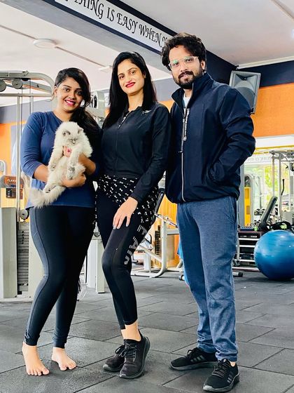 A happy moment with my clients and a furry friend. Our gym is a welcoming place for everyone.