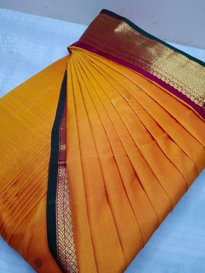 A beautiful mustard yellow saree with a maroon border. With my service, it takes less than five minutes to drape a saree like this.