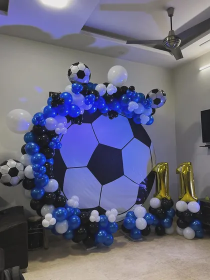 The football backdrop lit up with a cool blue light, adding to the atmosphere of the party.