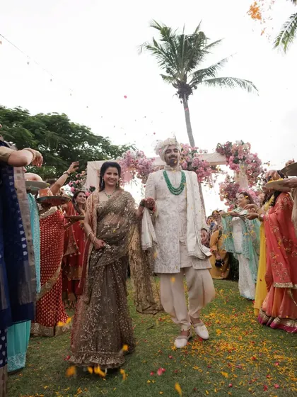 A beautiful moment from a choreographed groom's entry, where he is welcomed with a shower of flower petals by the bride's family.