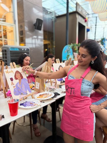 A guest adding the final details to her canvas at a birthday paint party. The atmosphere is always relaxed and encouraging, allowing everyone's creativity to flow.