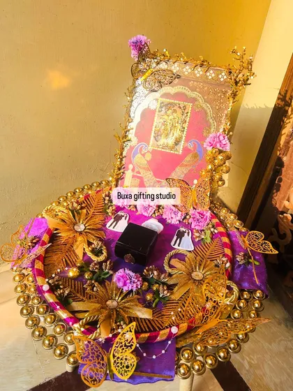 The engagement ring sits at the center of this opulent platter, surrounded by symbols of love and devotion.