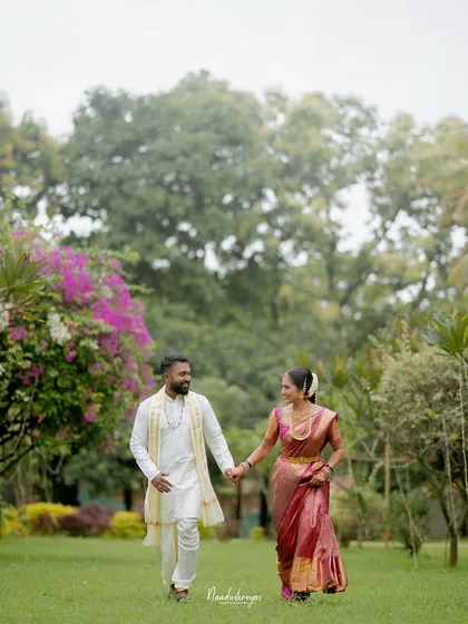 Walking hand-in-hand through a beautiful garden. This classic romantic shot symbolizes the start of their journey together as partners.