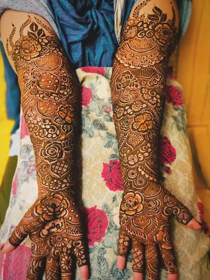 A full bridal design with the name 'Tauheed' on the palm.