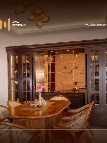 This stunning crockery and bar unit at Sobha Royal Pavilion adds glamour and functionality to the dining space, featuring dark wood, glass shutters, and integrated lighting.