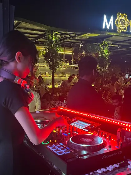 Spinning a Bollywood set at a stylish rooftop bar in Gwalior. I adapt my music to the venue, and for a place like this, it's all about creating a sophisticated yet high-energy party atmosphere that matches the beautiful setting.