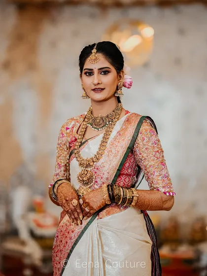 It's a joy to see my clients shine. Here is my beautiful bride Chethana, looking absolutely radiant on her wedding day in her custom-designed Kanchipuram saree and a meticulously hand-embroidered blouse that we created together.