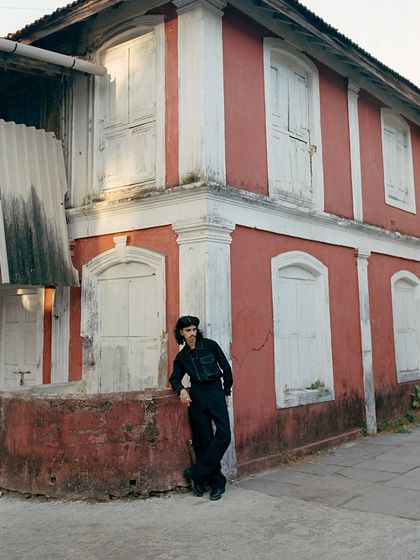 An environmental portrait from the same series, placing the model against a rustic Goan building. This demonstrates my ability to use location and architecture to build a world around the fashion.