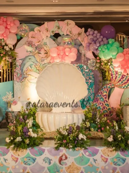 I love creating enchanting underwater worlds, complete with shimmering sequin backdrops and a giant clamshell throne for the birthday star. This mermaid theme is a perfect example of how I blend custom props with balloon art to create a magical atmosphere.