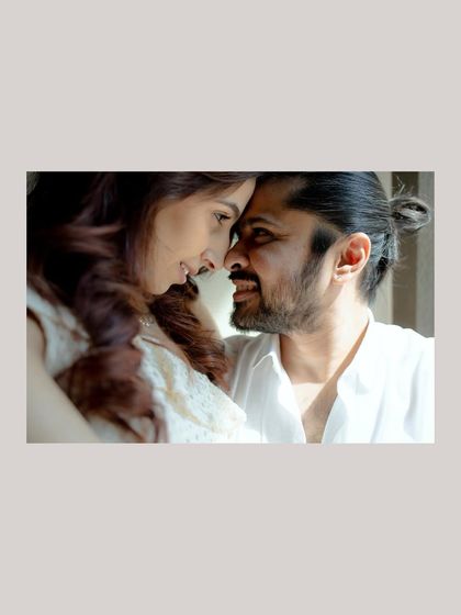 A close-up, intimate portrait showing the couple's deep connection. The focus is on their expressions as they share a quiet moment, forehead to forehead.