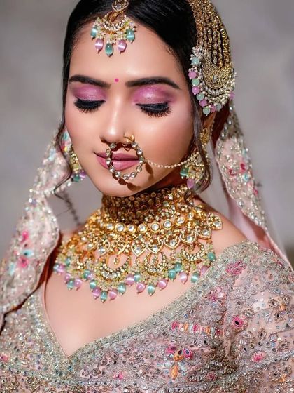 A beautiful profile of the bride, showcasing the intricate Passa jewelry and how the makeup complements it. The skin has a soft, airbrushed finish.