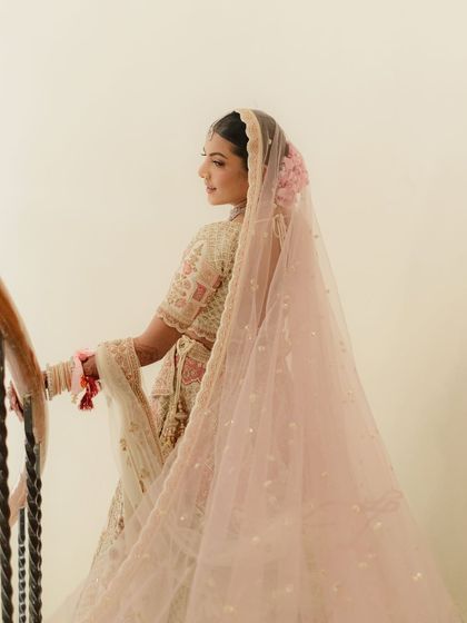 The back profile shows how every detail matters. The makeup is seamless from every angle, and the hairstyle with fresh flowers completes this ethereal bridal look.