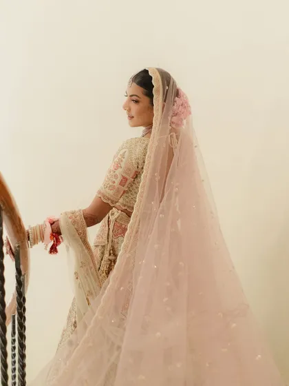 The back profile shows how every detail matters. The makeup is seamless from every angle, and the hairstyle with fresh flowers completes this ethereal bridal look.