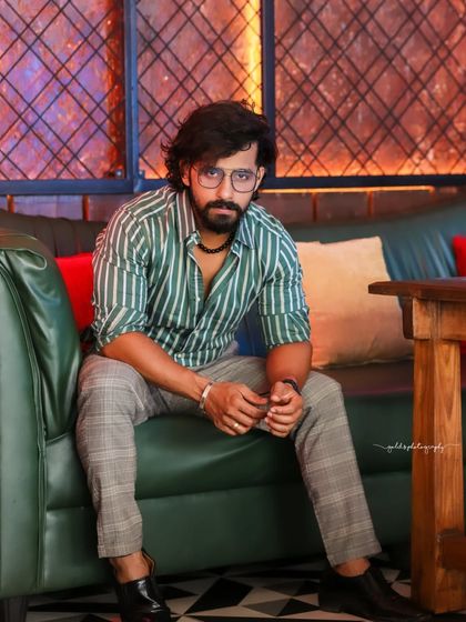 A collection of indoor portraits of an actor in a stylishly casual striped shirt. The moody lighting of the cafe setting adds a cinematic and modern feel, perfect for a character portfolio.