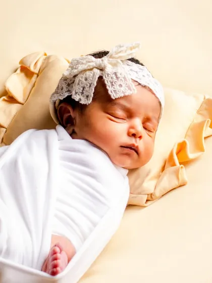 A peaceful, sleeping baby is a beautiful sight. We specialize in safe and comfortable swaddling techniques to keep your newborn snug and content, allowing us to capture these serene moments.