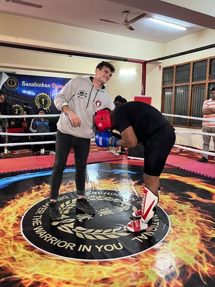 A moment of respect in the ring between a coach and a student after a hard-fought match.
