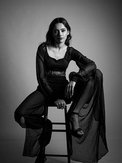 A dramatic black and white portrait. The makeup was sculpted to create dimension and highlight the model's bone structure under the studio lights.