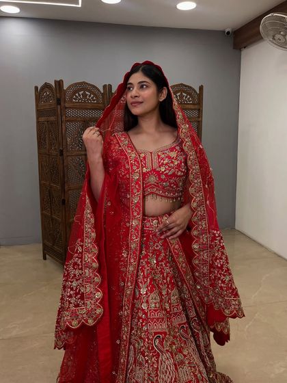 The double dupatta style adds a layer of royalty. I help you style the outfit perfectly for your grand entrance.