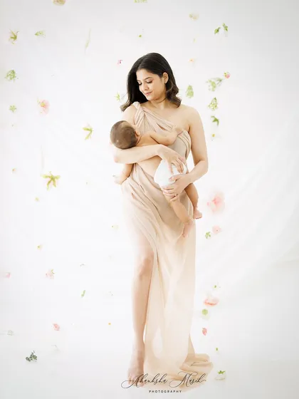 A duplicate of the full-length serene portrait, this image continues to embody the pure and timeless love between a mother and her newborn.