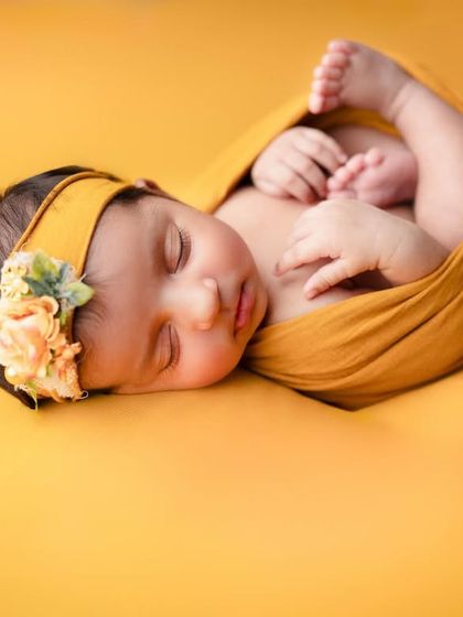 This is what our newborn shots are about, just your newborn. The bold yellow background and simple wrap make this a vibrant yet minimalist portrait.