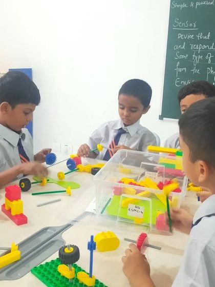 A classroom full of engaged students at TSGM, each working on their own LEGO creations. Our programs cater to individual creativity while following a structured curriculum.
