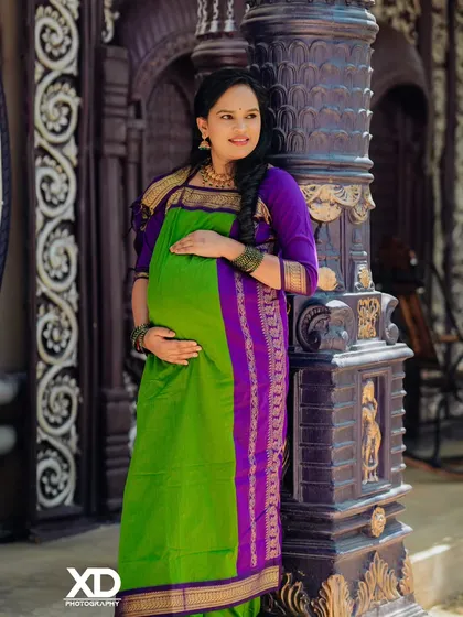A classic solo portrait of the mother-to-be, her hand on her hip, exuding confidence and joy.