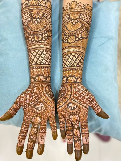 A clear, well-lit shot of the floral and elephant mehandi, showing the delicate details and the rich color of the henna.