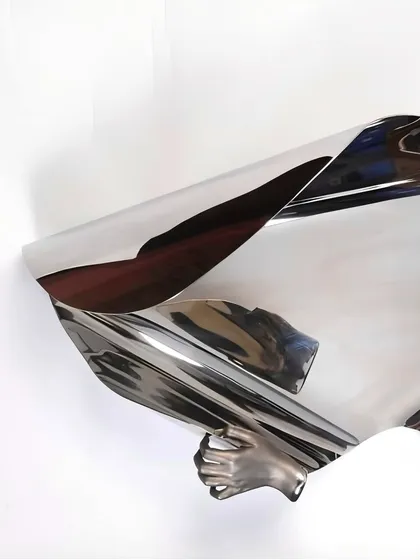 Another angle of "The Power of Being," showing the hand grasping the fluid metal form.