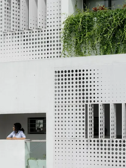 A close-up of the operable perforated screens on the LUCID House facade. This feature is a functional design solution that provides residents with control over their privacy and the amount of natural light entering their home.