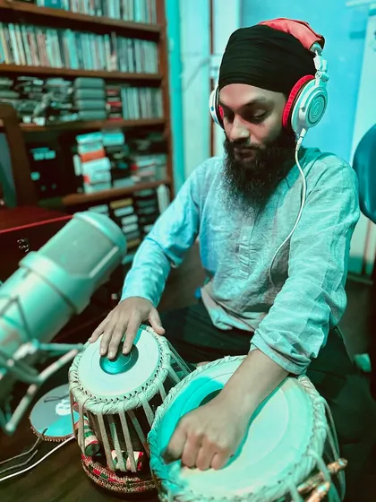 Focused on the intricate bols (strokes) during the kirtan recording. Each note is played with devotion and respect for the composition.