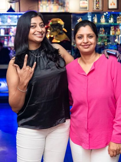 Two friends rocking out by the bar.