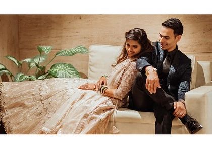 A relaxed, lifestyle portrait of the couple sharing a quiet moment on a sofa. These casual shots are a wonderful way to capture your connection in a comfortable setting.