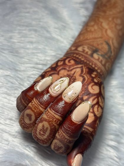 The full hand view shows how all the different art elements work together to create a cohesive and glamorous bridal manicure.