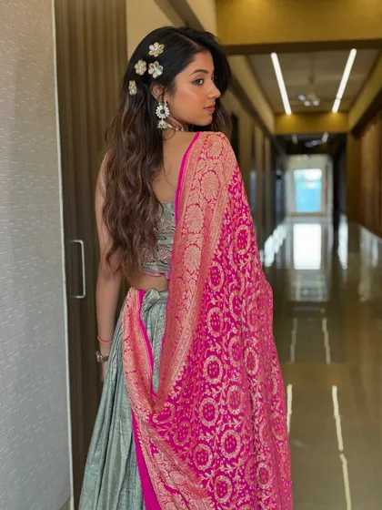 A back view of the soft textured waves with floral accessories, showing how the style looks with the dupatta draped over the shoulder.