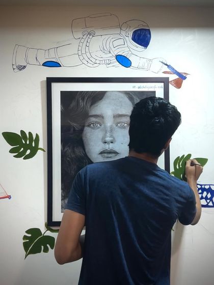 Me working on the green leaves of my wall mural. It's a slow process, but seeing the wall transform is incredibly rewarding.