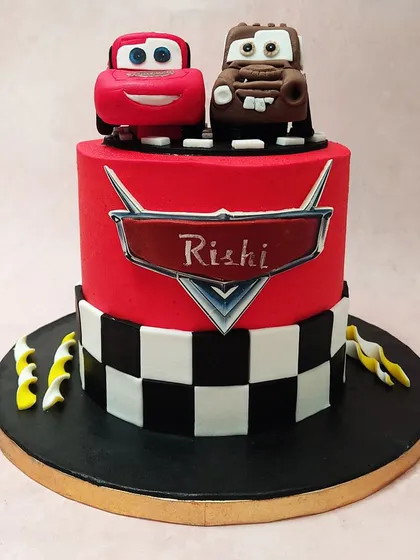 A straight-on view of our Cars movie cake, showcasing the iconic logo personalized with the birthday boy's name.